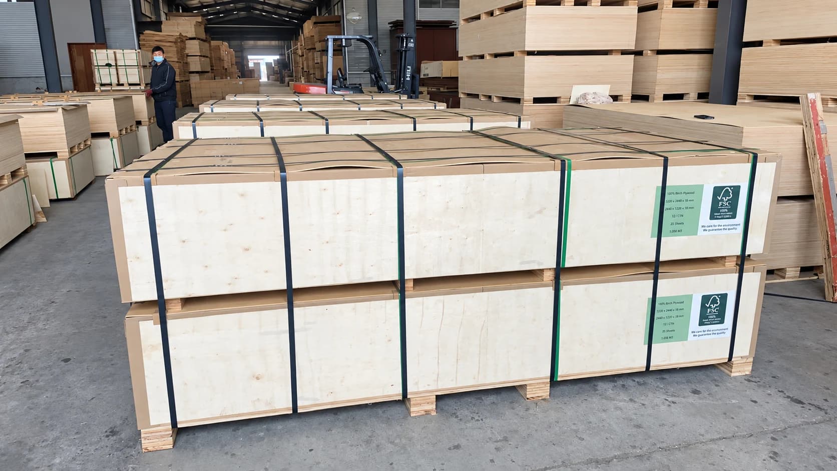 Protected plywood export packages staged in a finished-goods warehouse.