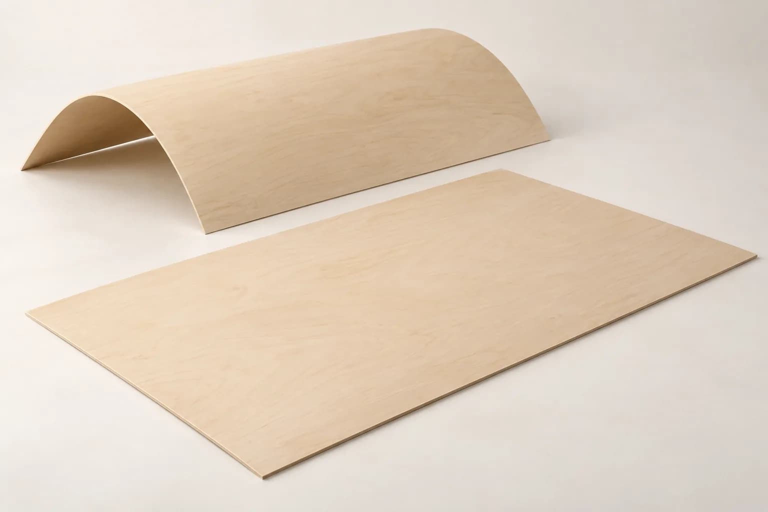 A flat thin birch plywood sheet and a curved thin plywood sheet with pale wood faces