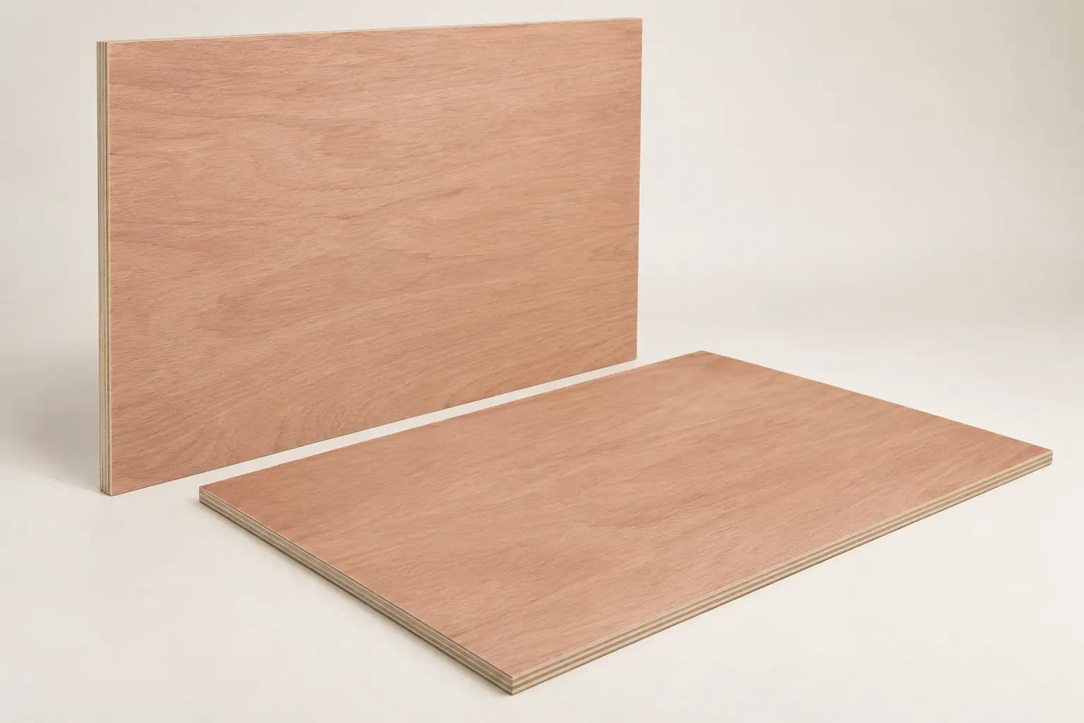 Okoume plywood panels with warm reddish veneer faces and bonded layers visible only at the narrow cut edges